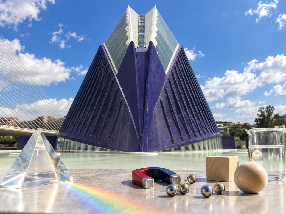 AI-generated illustration: CaixaForum València exterior with subtle light refraction, a magnet and simple science experiment pieces.