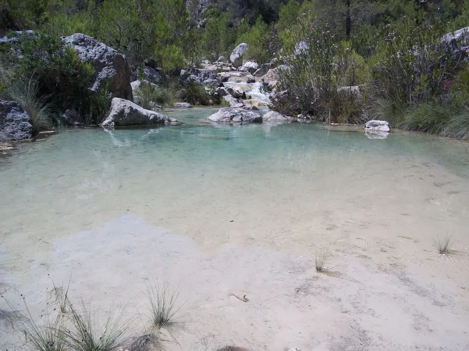 Shallow natural pool and stream among rocks on Río Fraile in Bicorp.